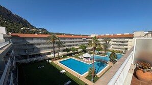 A hotel with multiple swimming pools, a covered area, and a view of the surrounding landscape. - Holiday Apartment "Mar D'or 223" with Shared Pool, Terraces & Wi-Fi (girona)