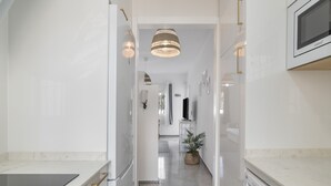 A modern kitchen with a built-in microwave, a stove, and a sink.