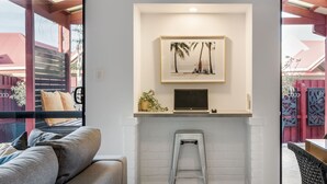 A modern room with a white brick fireplace, a laptop on the mantel, and a framed picture above it. - CONVENIENTLY LOCATED 250M (APPROX) TO THE EXQUISITE SHORES OF GEOGRAPHE BAY (Dunsborough)