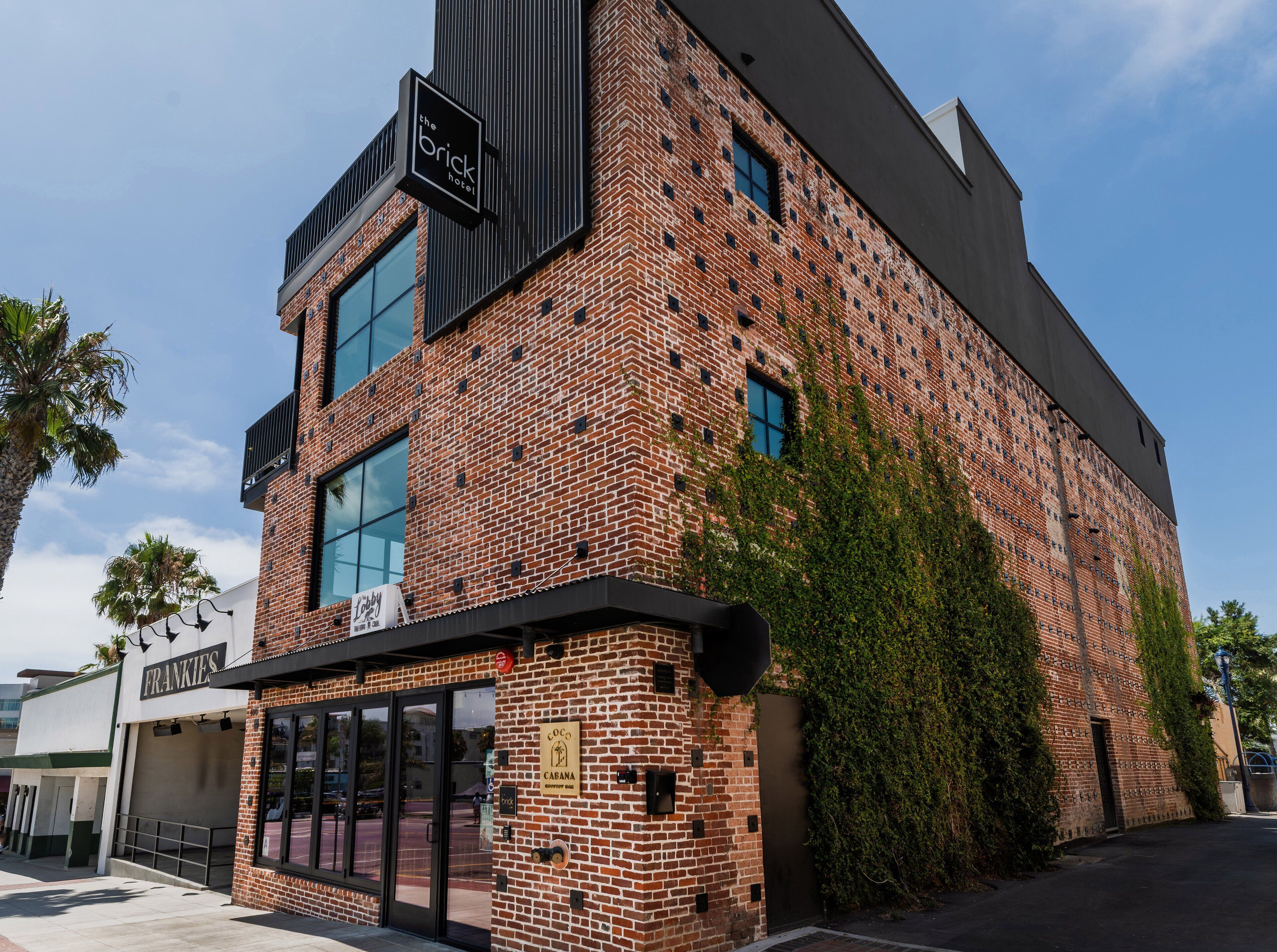 A brick building with a sign for 'The Brick Hotel' and another for 'Coco Cabana.'
