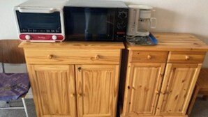 A wooden cabinet with two microwave ovens on top. - 5-PERSON APARTMENT LA MONGIE AT THE FOOT OF THE SLOPES (Bagnères-de-Bigorre)