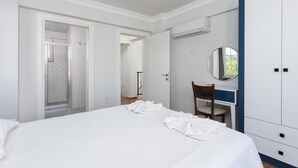 A bedroom with a large bed, a desk with a chair, a wardrobe, and an air conditioning unit. - Villa Vista - Four Bedroom Villa, Sleeps 8 (Dalyan)