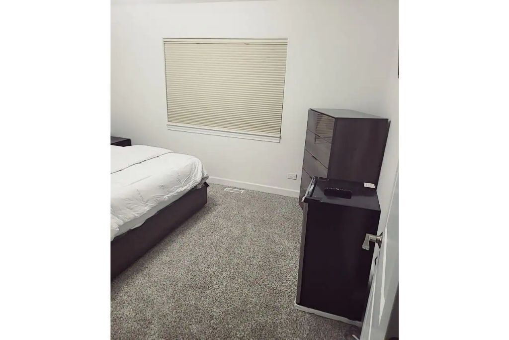 A cozy bedroom in a home with high-tech amenities