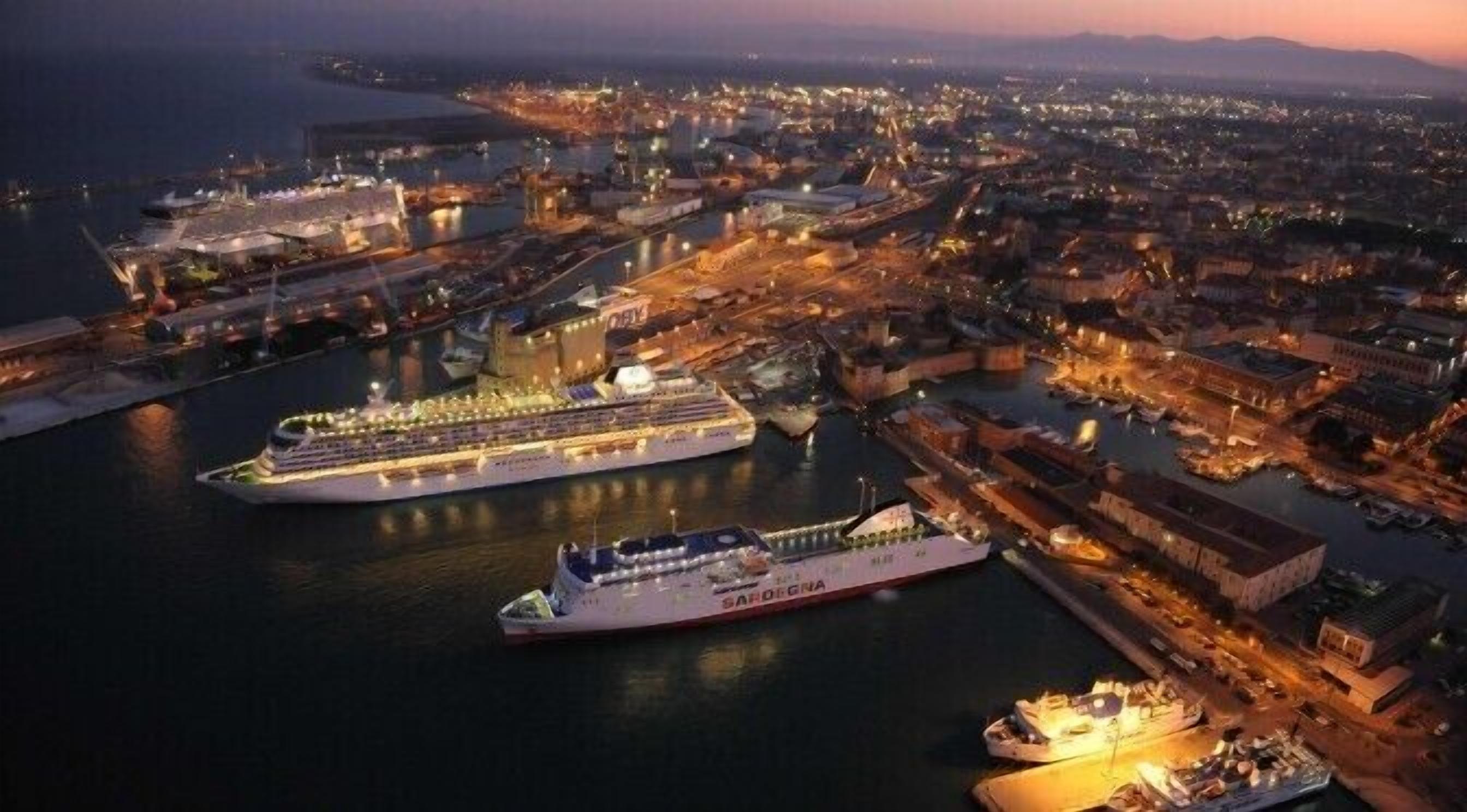 A large cruise ship docked at a port with a cityscape in the background.