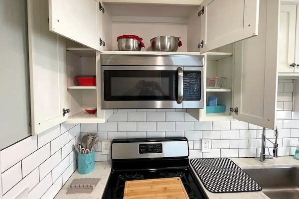 Utensilis de cuina, vaixella i coberteria i una taula de menjador