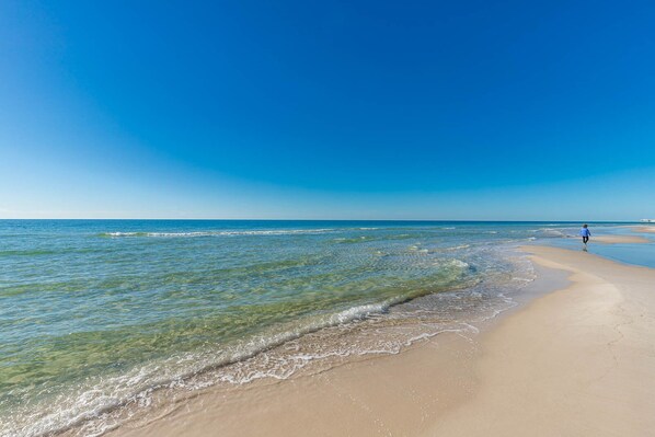 Stroll along the pristine shoreline with stunning views and gentle waves at your beach getaway to Phoenix Orange Beach II