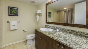 A bathroom with a sink, mirror, toilet, and towel rack. - Islander on the Beach 232: Beach Resort Room w/ View, AC & Kitchenette (Kapa'a)