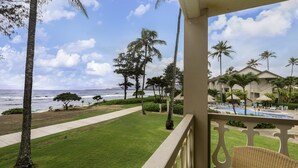 A balcony with a view of a pool, palm trees, and a beach. - Islander on the Beach 232: Beach Resort Room w/ View, AC & Kitchenette (Kapa'a)