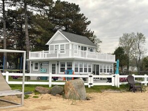 Taylor's residence features a two-story building with a balcony and a white exterior, surrounded by a fence.