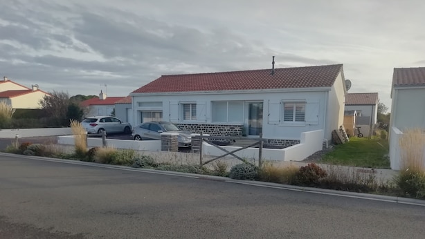 A modern two-story house with a red-tiled roof, a brick exterior, and a small front yard. - Studio close to ocean and shops (Givrand)