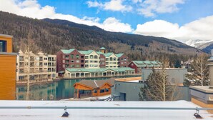 A hotel with multiple buildings, a ski lift, and a lake. - Spacious Condo/Mountain Views/Great Amenities (Keystone)