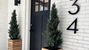 A black door with a window, white brick wall, and the numbers 234 on the wall. - *New 3BR/2BA* ~ 200 ft Lake Frontage ~ Lakehaven (Hot Springs)