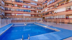 A multi-story residential building with a central courtyard featuring a swimming pool. - Nice apartment in Torrevieja with WiFi (Torrevieja)