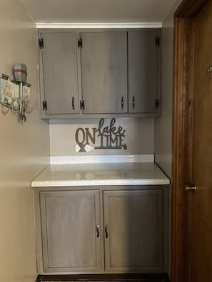 A kitchen with grey cabinets, a countertop, and a sign that reads "ON lake TIME". - Pymatuning Lake Walking distance to Espyville Marina! (Pymatuning Central)