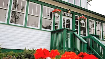 Stroll through the charming L'Orpailleur Auberge, surrounded by a beautifully maintained garden with vibrant flowers.