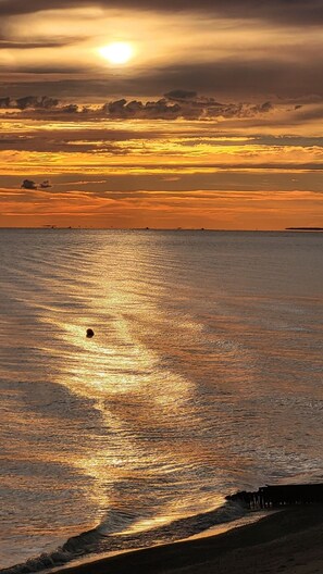 On the beach, sun loungers, beach towels