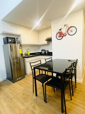 Fridge, electric kettle, cookware/dishes/utensils, paper towels