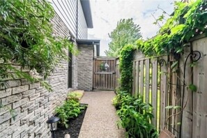 Stroll through a serene garden setting, surrounded by lush greenery and a tranquil atmosphere.