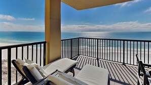 A balcony with two sun loungers facing a beach. - Romar House #1004A | Your Beachside Retreat! (Orange Beach)