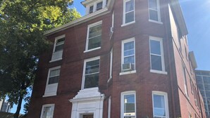 A multi-story brick building with a central entrance, large windows, and a small balcony. - Cantrell’s on Broadway #1 (Nashville)