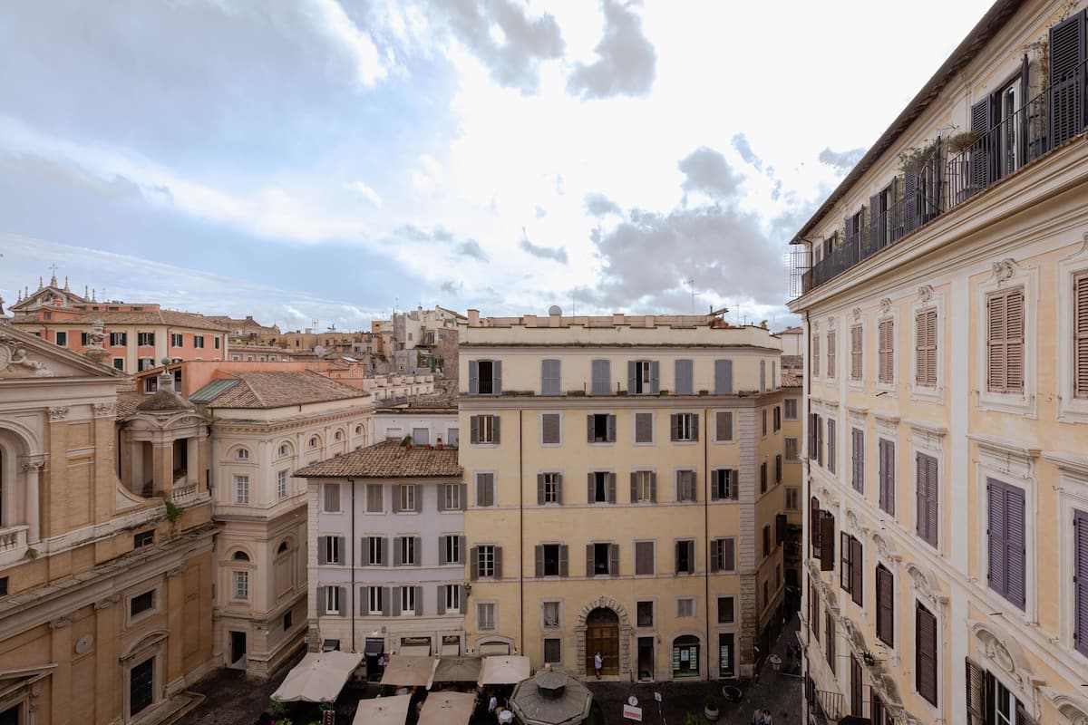 A historic European street with classical architecture, narrow alleyways, and traditional buildings.