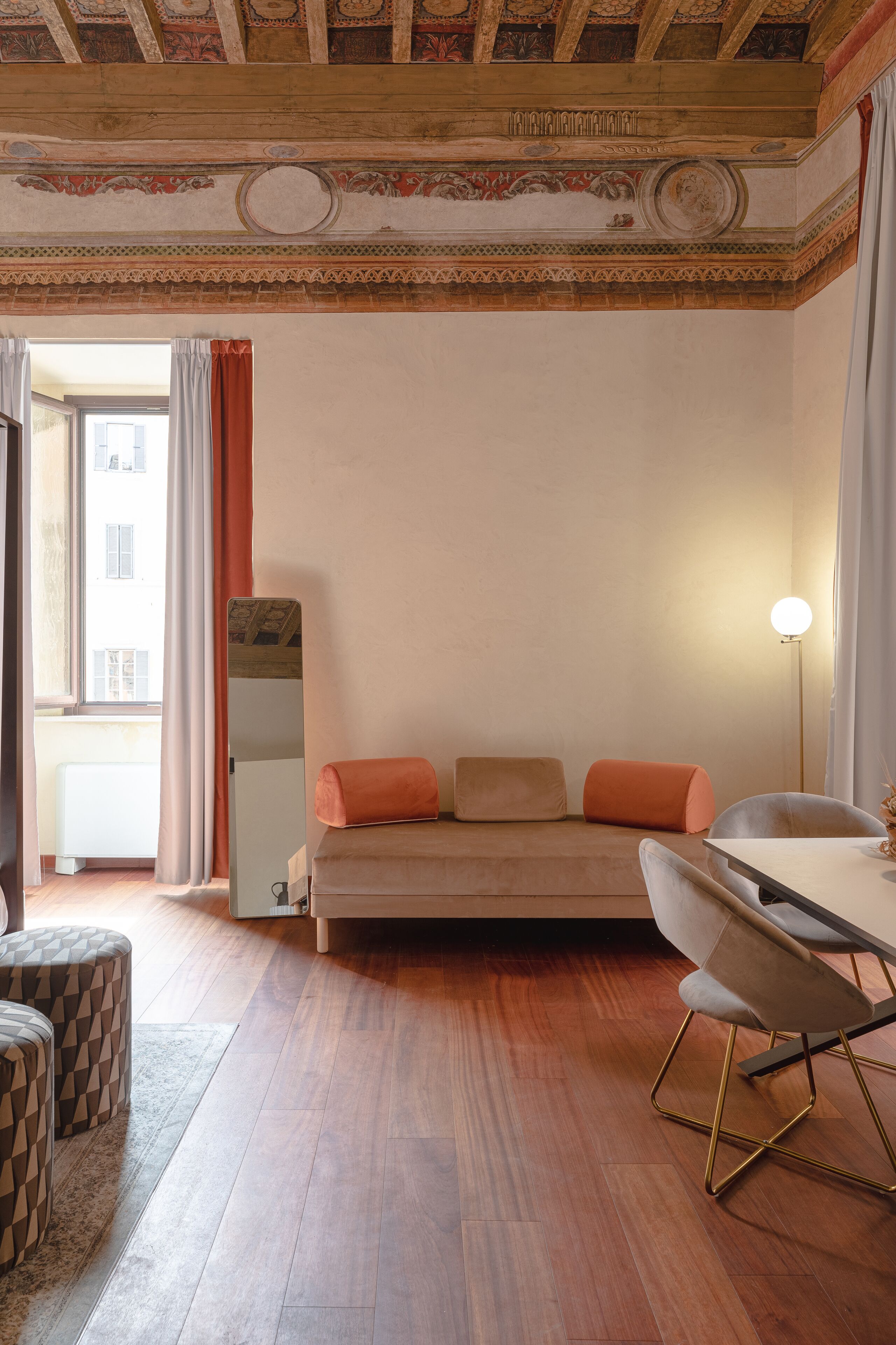 A modern room with a sofa, a dining table, and a chair.