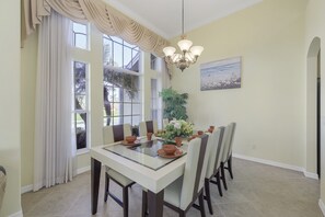 Enjoy meals in this dining area with a glass-top table and six comfortable chairs.