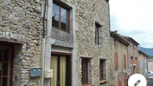 A stone building with multiple windows and doors, featuring a traditional architectural style. - Lovely renovated Cottage in Puivert (Puivert)
