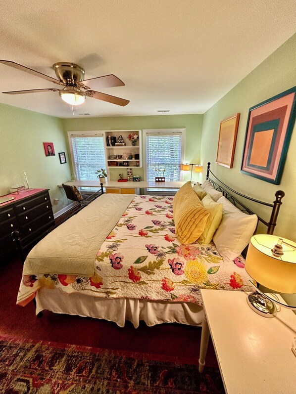 A bedroom with a bed, a nightstand, a dresser, a ceiling fan, a window with blinds, and a bookshelf. - Beer/Wineries, firpit & hottub (Crozet)