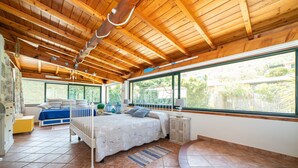 A bedroom with a wooden ceiling, a large window, a bed, and a small table. - BEAUTIFUL APARTMENT X 5 WITH HOT-HUB POOL ABOUT 2 KM FROM THE SEA (Imperia)