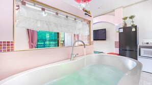 A modern bathroom with a freestanding bathtub, a vanity with a mirror, and a sink.