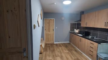 Apartment, Multiple Beds | Private kitchen | Fridge, microwave, stovetop, electric kettle