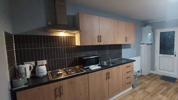 Apartment, Multiple Beds | Private kitchen | Fridge, microwave, stovetop, electric kettle