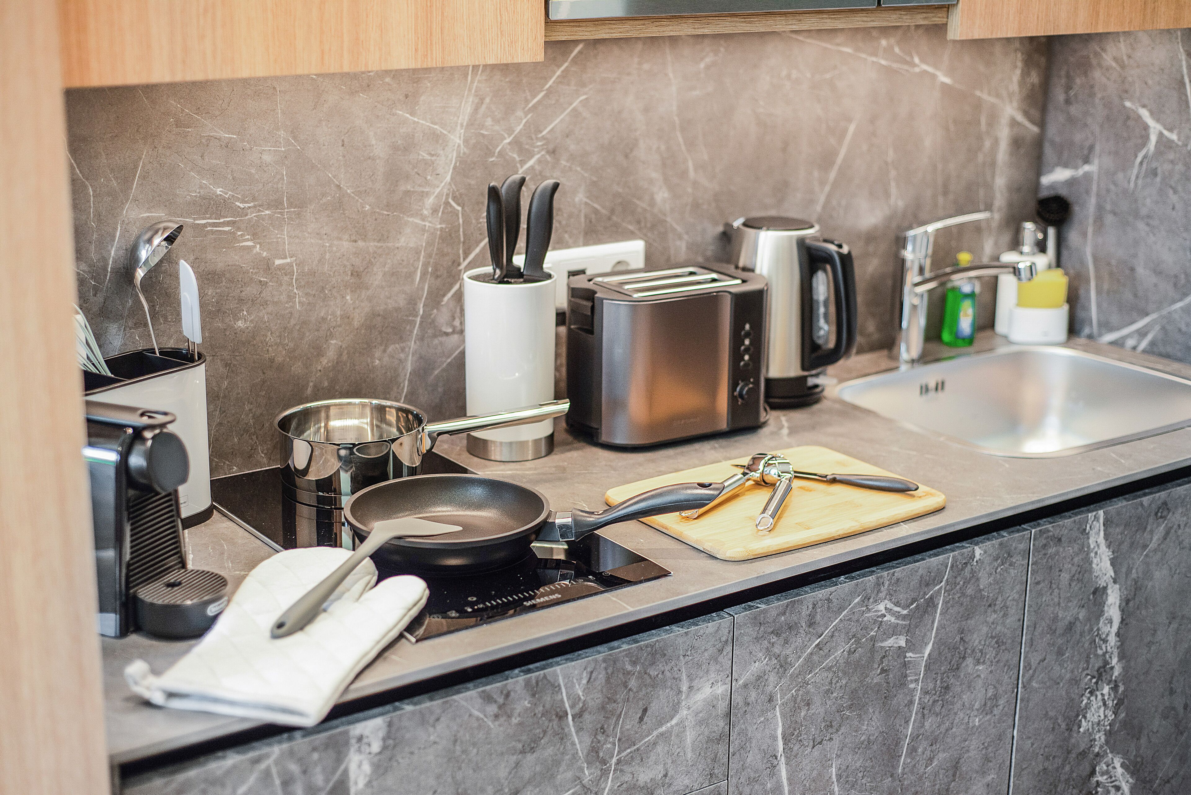 A modern kitchen with a built-in stove, toaster, and sink.