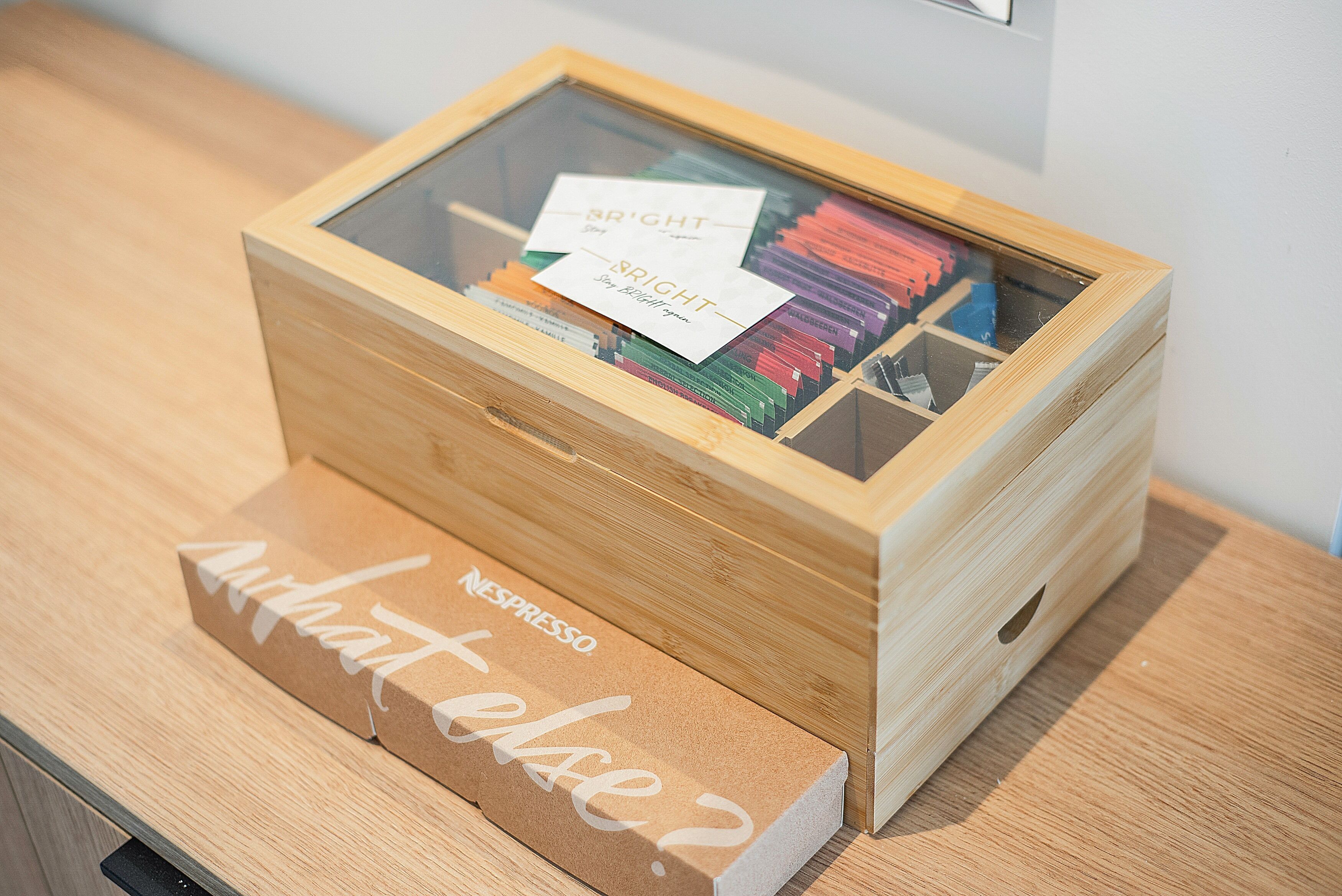 A wooden box with a glass front containing various items.