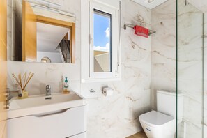 Combined shower/tub, hair dryer, towels, toilet paper