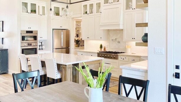 A modern kitchen with white cabinetry, stainless steel appliances, and a central island. - Luxury Farmhouse with Pool - Perfect for Groups (Conroe)