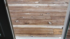 A wooden deck with outdoor furniture including a table and chairs. - Ohio Street Retreat-hot tub, pool, massage chair (Prairie du Chien)