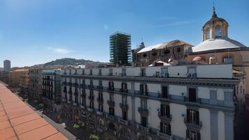 A historic building with multiple floors, balconies, and a dome structure.