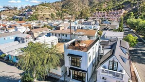 A residential area with a mix of modern and traditional architecture, including a house with a unique spiral design on the roof.