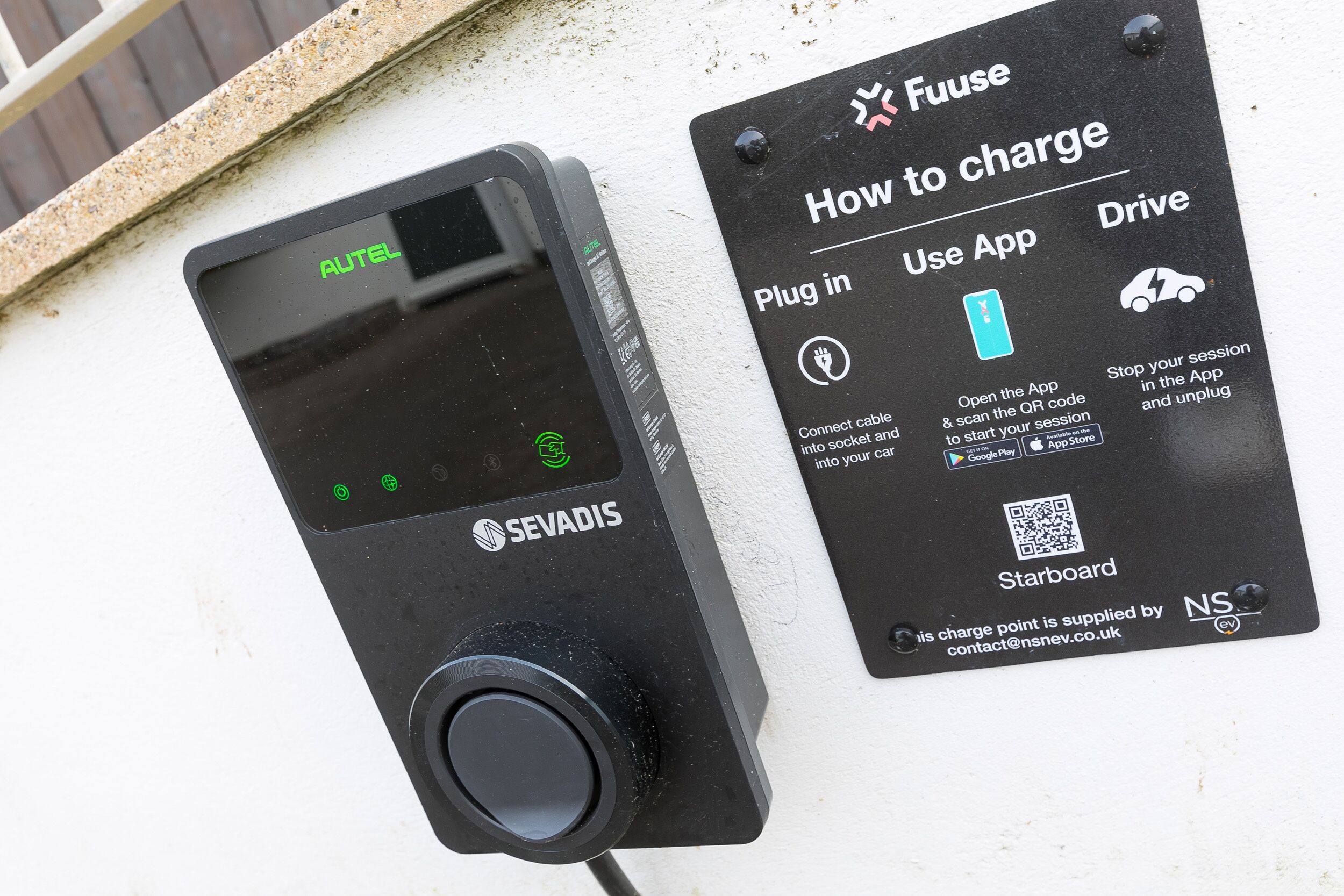 A charging station with a digital display and a charging plug.