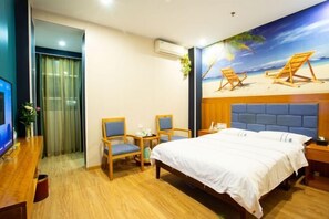 A hotel room with a bed, two chairs, a small table, a TV, and a beach mural on the wall. - Super 8 Hotel (Quanzhou Nan'an Hongse Laifulong Shopping Plaza) (Nan'an)