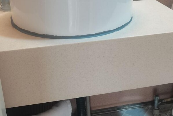 A white cylindrical object on a beige countertop. - Daxiagu Ligong Guoyuan Holiday Hotel (Ruyuan)