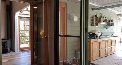 Adorable Guest House with fireplace in forest setting. One or two Queen Beds.