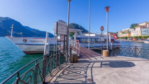 A boat docked at a pier with a sign indicating 'PARTENZE' and 'GANDRIA'. - Ca Gina Panoramica in Lugano (Lugano)