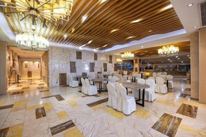 A spacious lobby with marble flooring, multiple seating areas, and modern chandeliers. - Meilin Hotel (Anji)