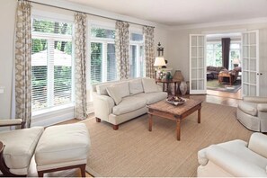 Relax in this inviting living space with a sofa, armchairs, and chaise lounge.