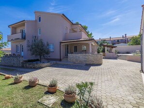 Stroll through the charming courtyard, surrounded by lush greenery and a beautiful garden.