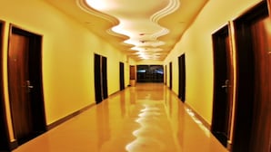 A long, polished hallway with doors on both sides, leading to a darkened area at the end. - GOLDEN PALACE HOTEL (Kuala Lumpur)