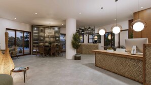 A modern reception area with a wooden reception desk, a chandelier, and a view of the outdoors through large windows. - Cretan Seaside Boutique Hotel (Hersonissos)